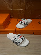 Hermes white slide sandals with logo band strap and rounded open-toe design