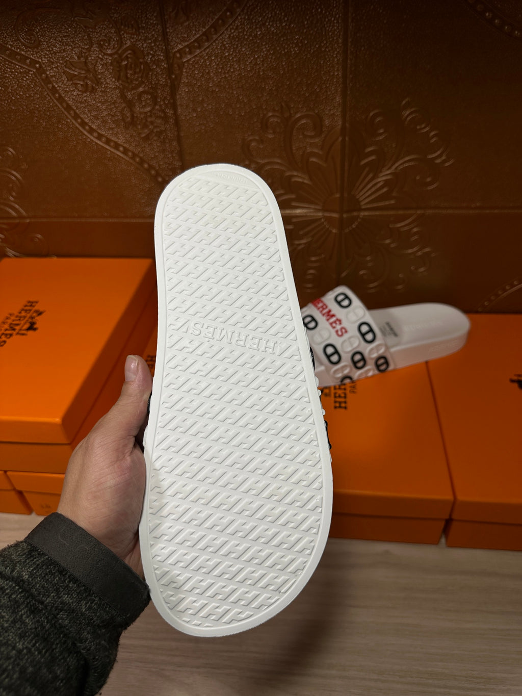 Hermes white slide sandals outsole with textured traction pattern