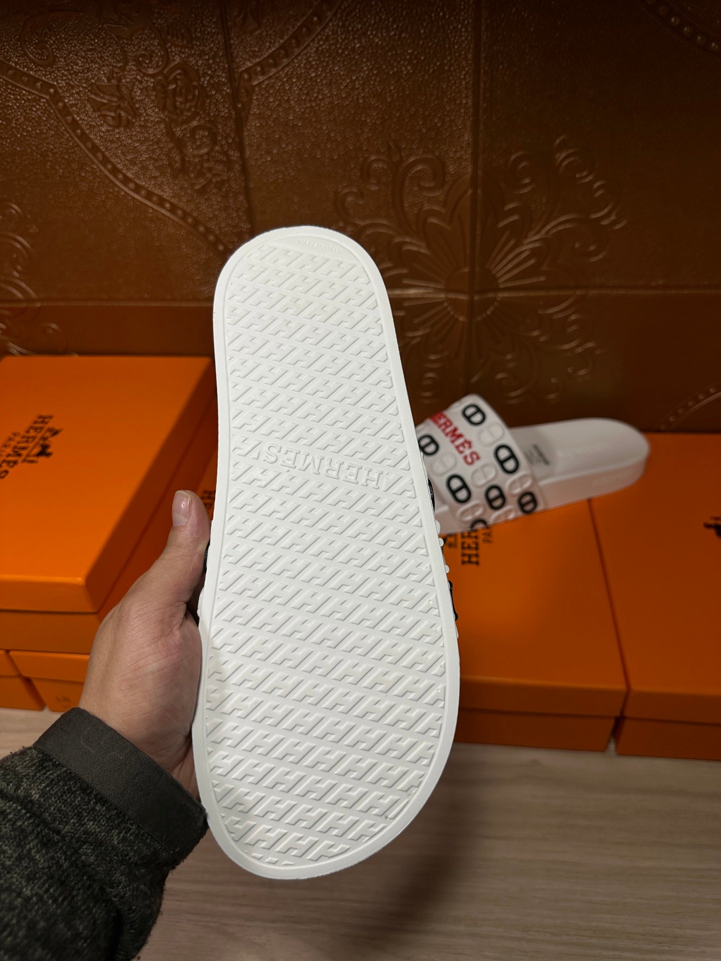 Hermes white slide sandals outsole with textured traction pattern