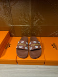 Hermes slide sandals with dark brown footbed and multicolor logo strap, flat sole