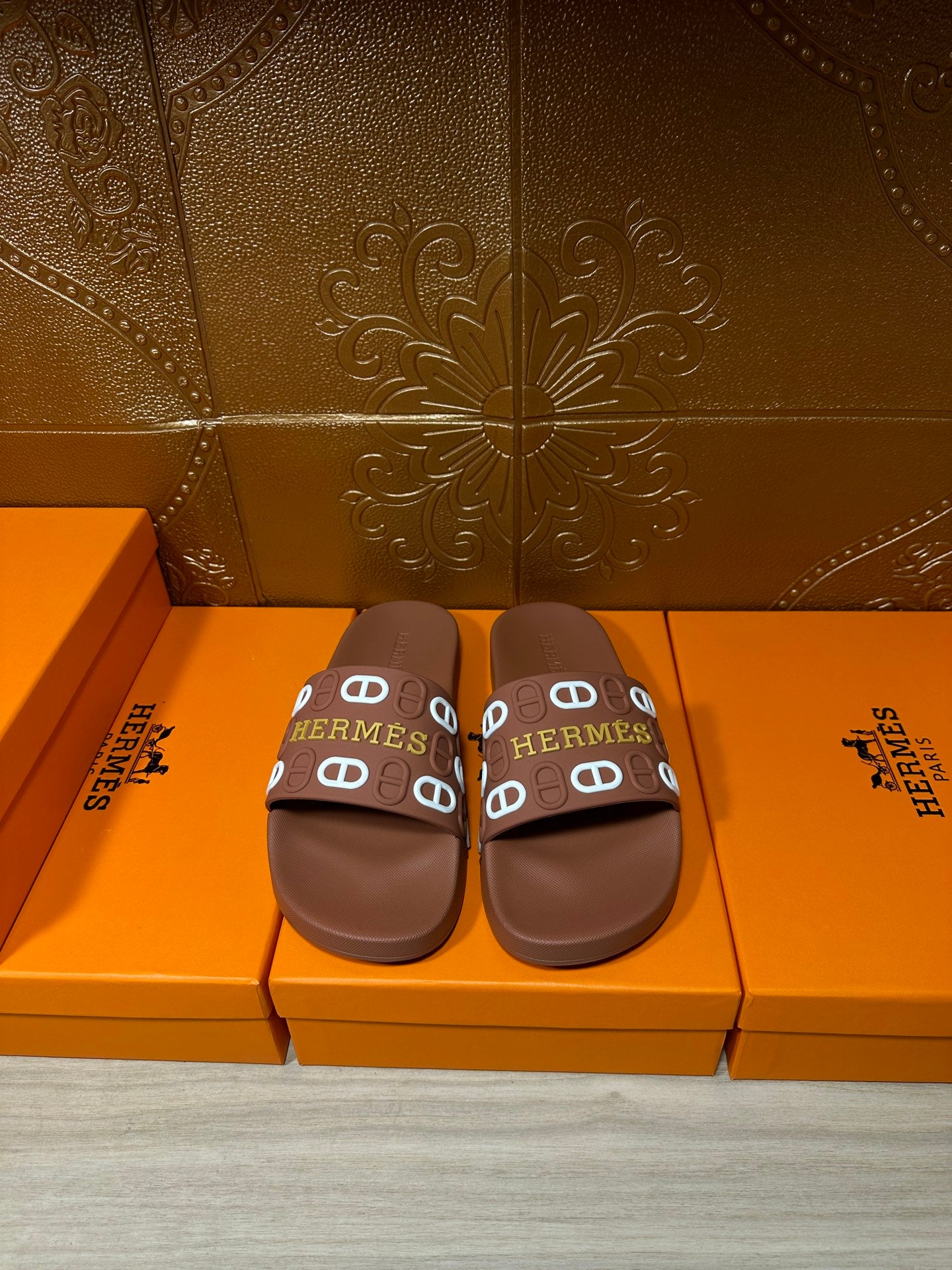 Hermes slide sandals with dark brown footbed and multicolor logo strap, flat sole