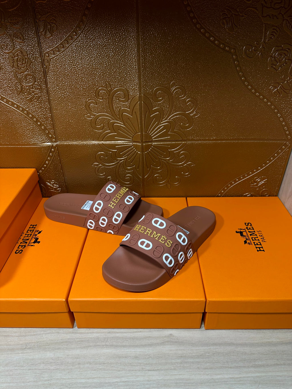 Hermes slide sandals with dark brown footbed and multicolor Hermes logo strap