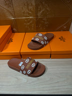 Hermes slide sandals pair on box, dark brown footbed with logo-printed strap