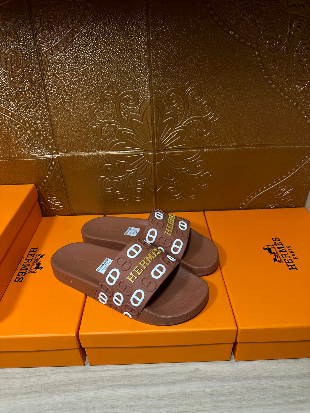 Hermes slide sandals with dark brown footbed and logo-printed strap across top
