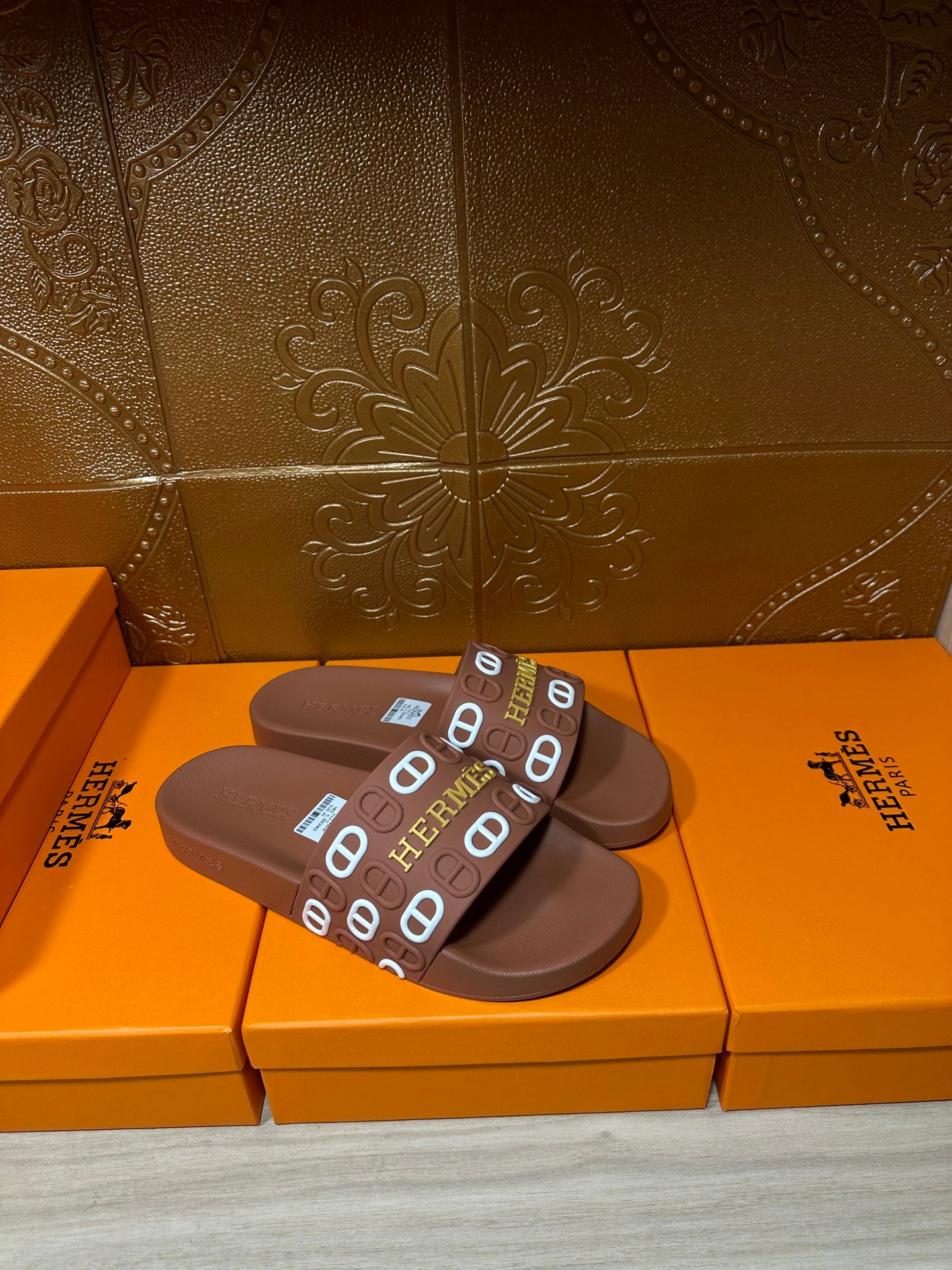 Hermes slide sandals with dark brown footbed and logo-printed strap across top