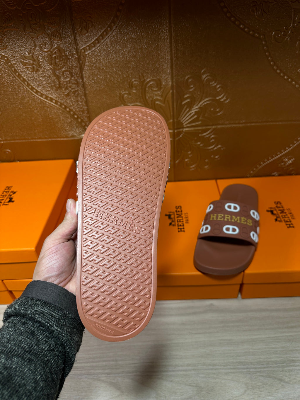 Hermes slide sandal outsole view in pink, textured tread with logo branding