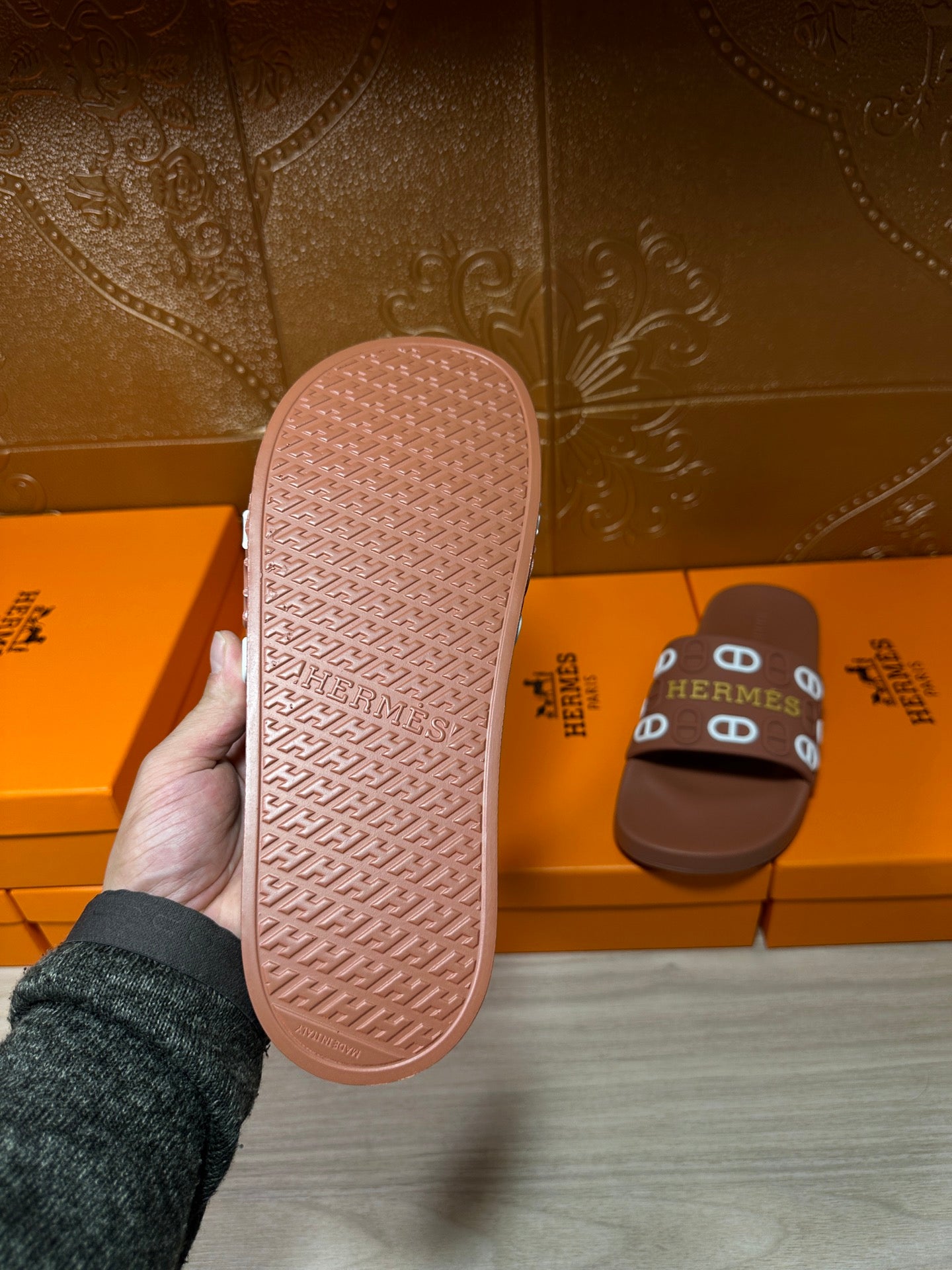 Hermes slide sandal outsole view in pink, textured tread with logo branding