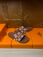 Hermes slide sandals with dark brown slide straps and repeating logo print
