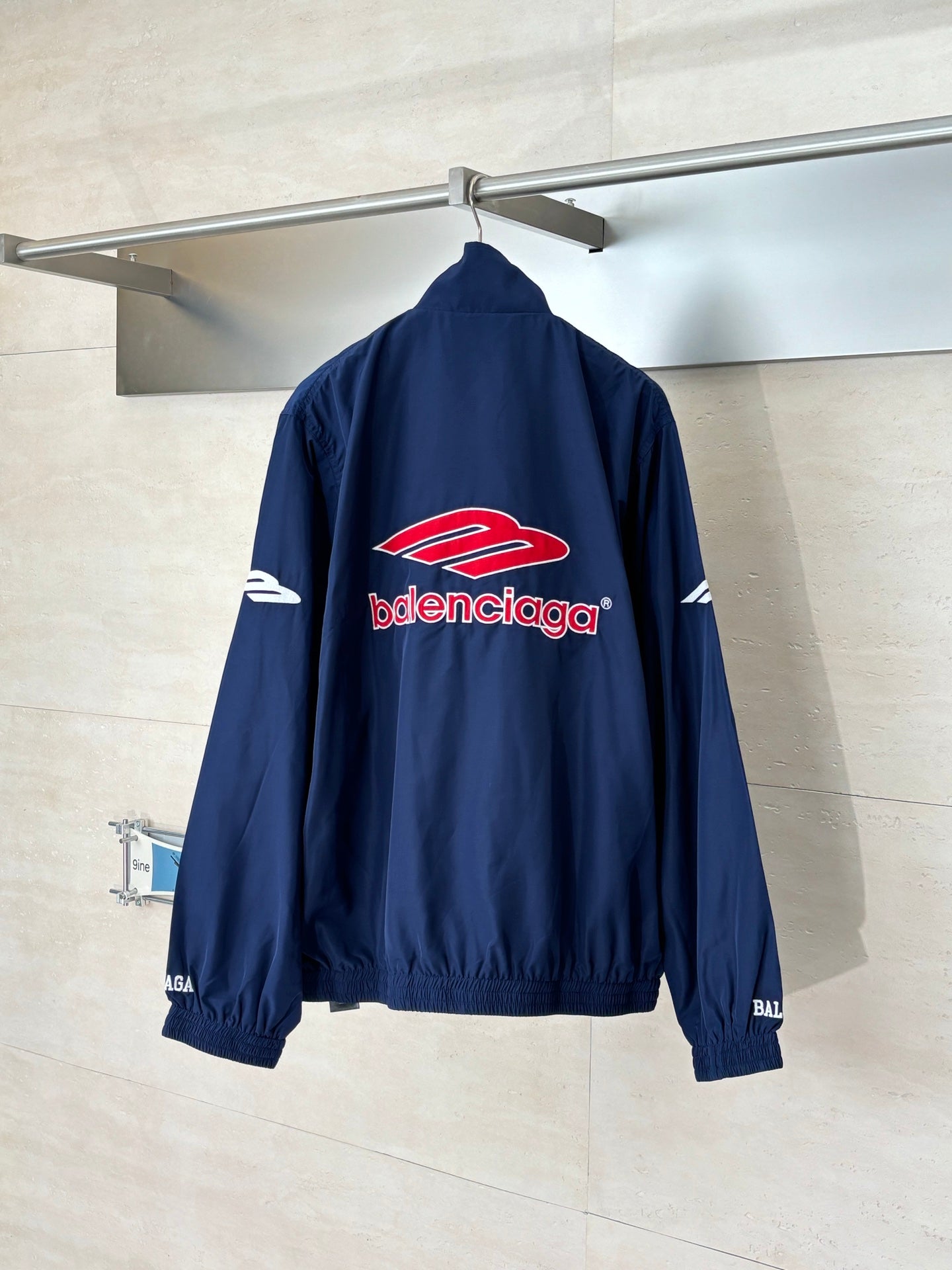 Balenciaga navy zip-up windbreaker jacket with large chest logo and elastic hem