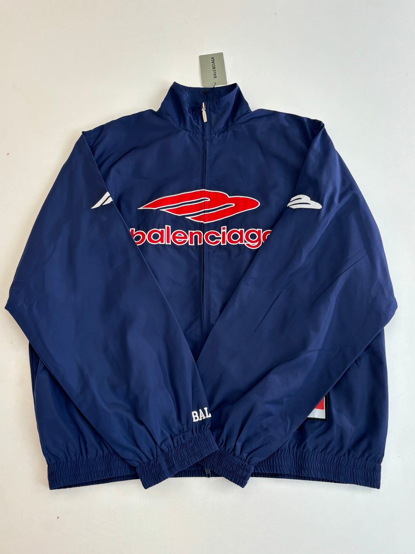Balenciaga navy zip-up jacket with red logo graphic and stand collar