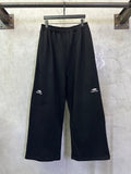 Black wide-leg pants with elastic waistband and drawstring