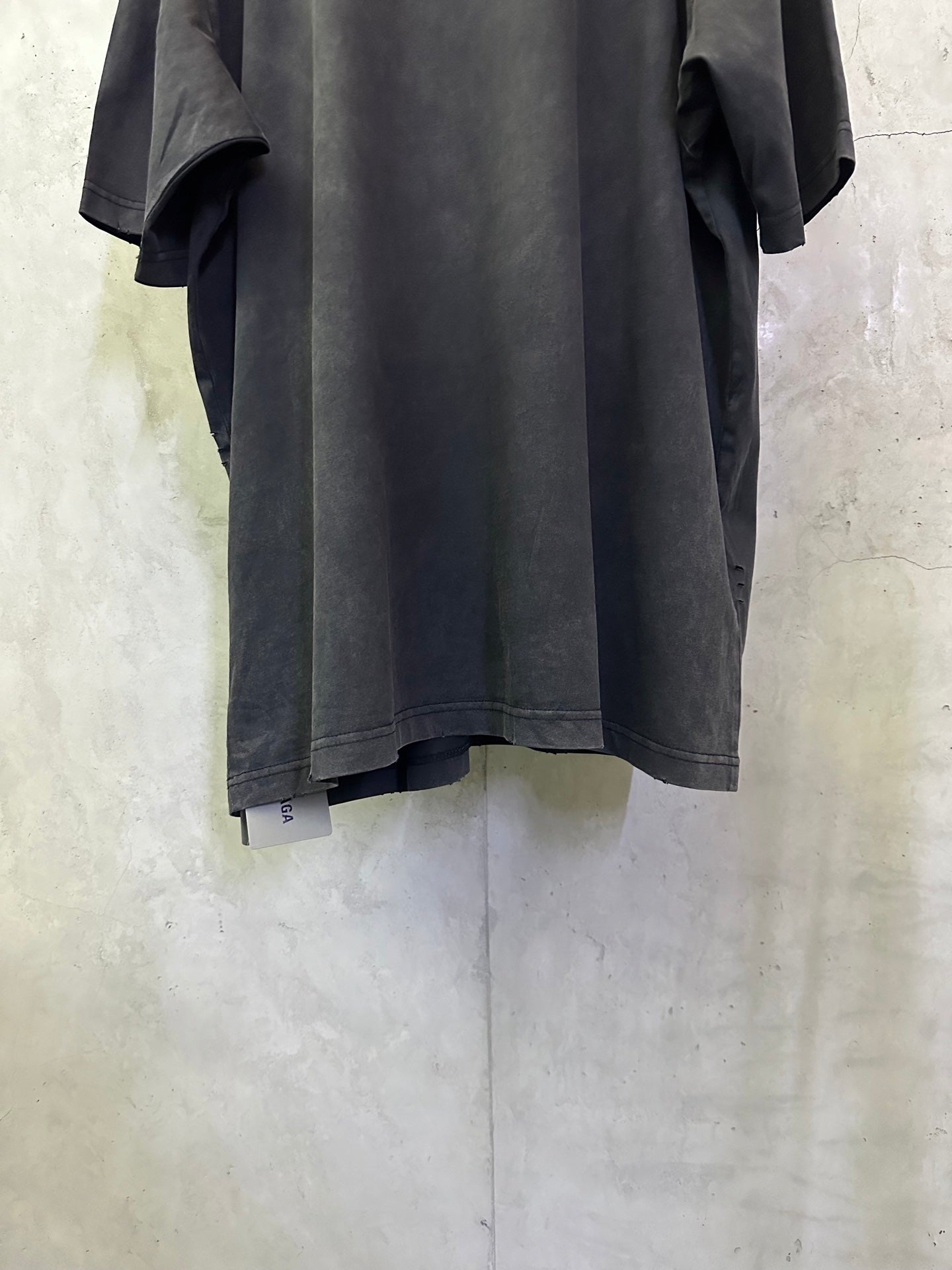 Black Balenciaga T-shirt back view from the side, loose drape and wide sleeves