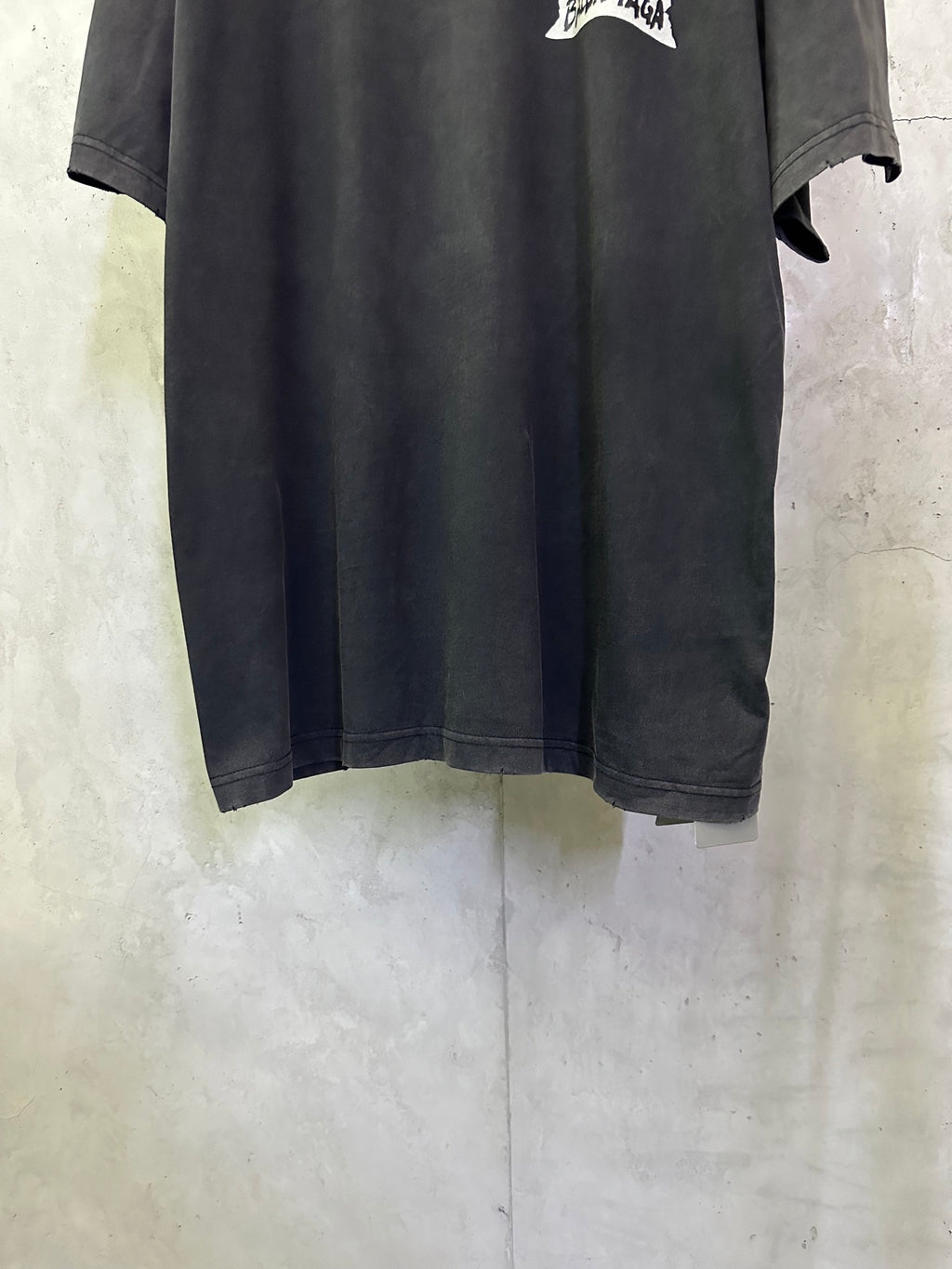 Black Balenciaga T-shirt hem and sleeves, side view with loose draped fit