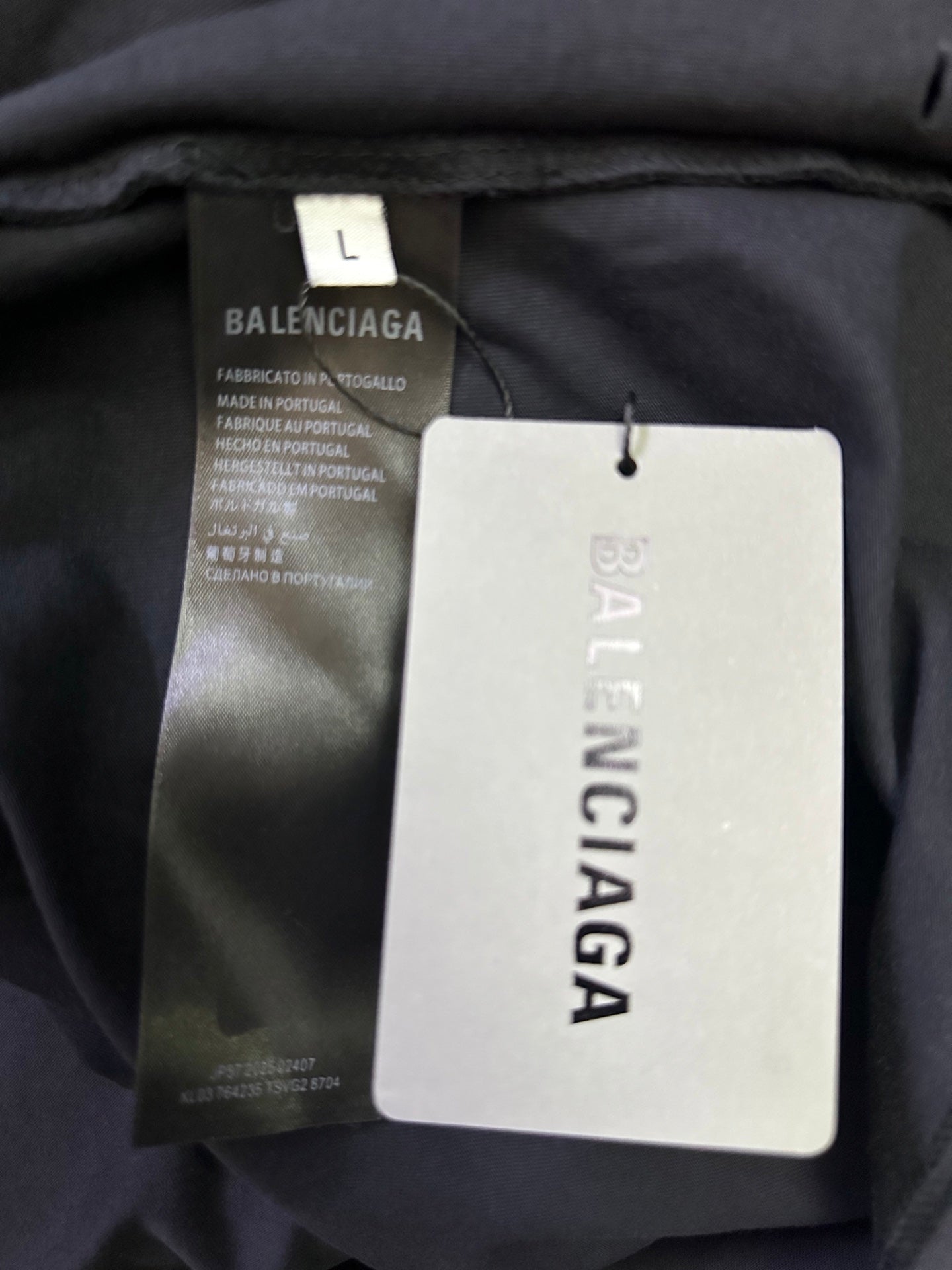 Balenciaga T-shirt showing size L tag and hanging product label