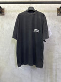 Dark charcoal short-sleeve T-shirt with Balenciaga logo patch at chest