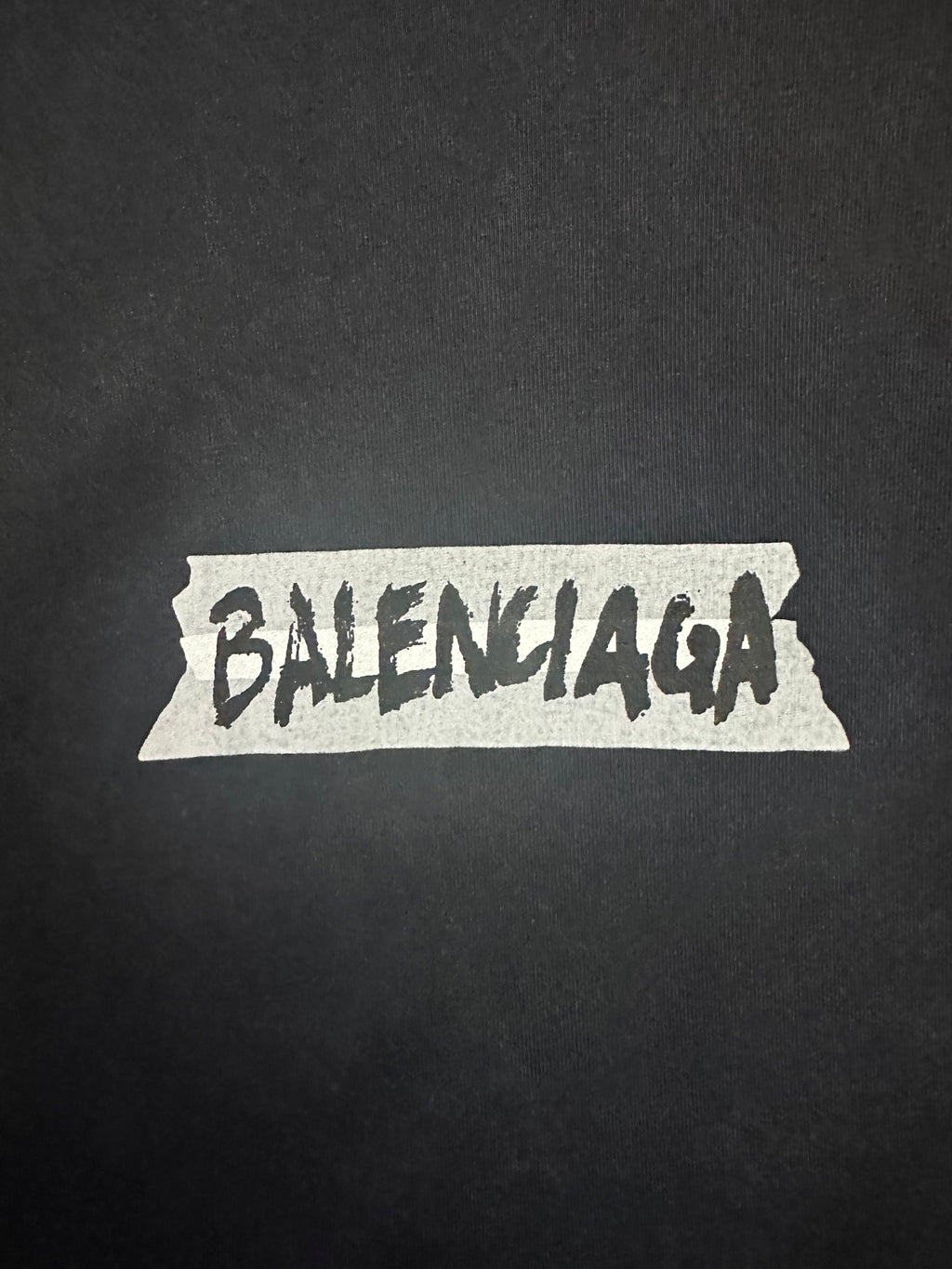 Balenciaga logo graphic on dark charcoal T-shirt fabric