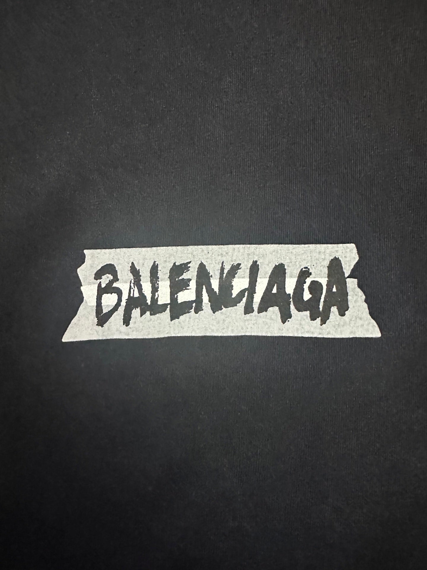 Balenciaga logo graphic on dark charcoal T-shirt fabric