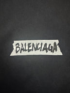 Black Balenciaga T-shirt fabric close-up with large distressed Balenciaga logo print