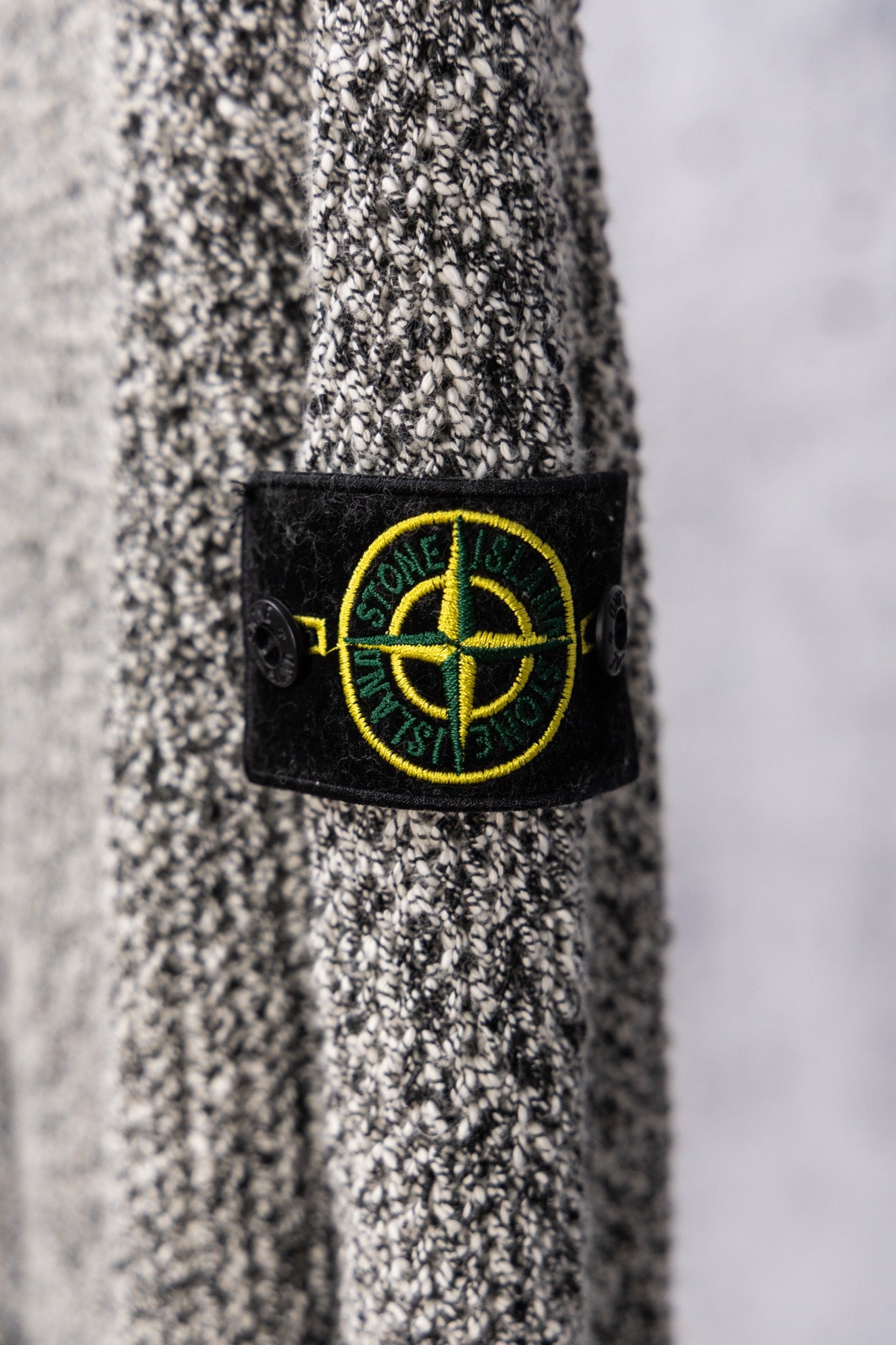 Stone Island speckled knit jacket with black logo patch, close-up