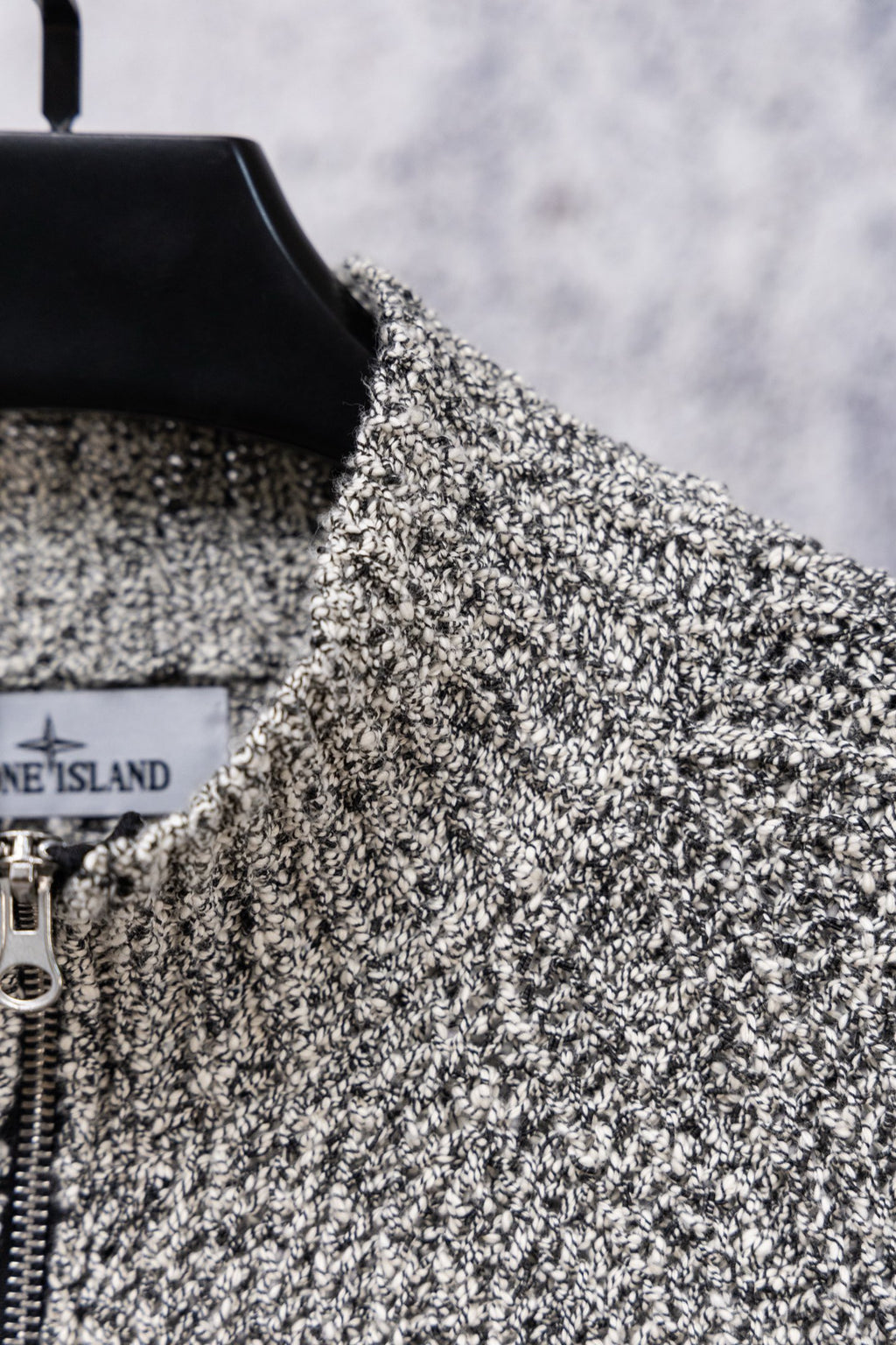 Speckled knit zip jacket with black shoulder trim and front zipper