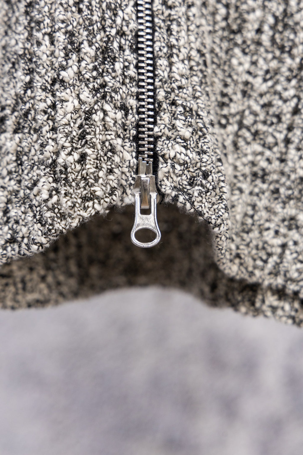 Stone Island speckled knit jacket zipper and metal pull tab, close-up
