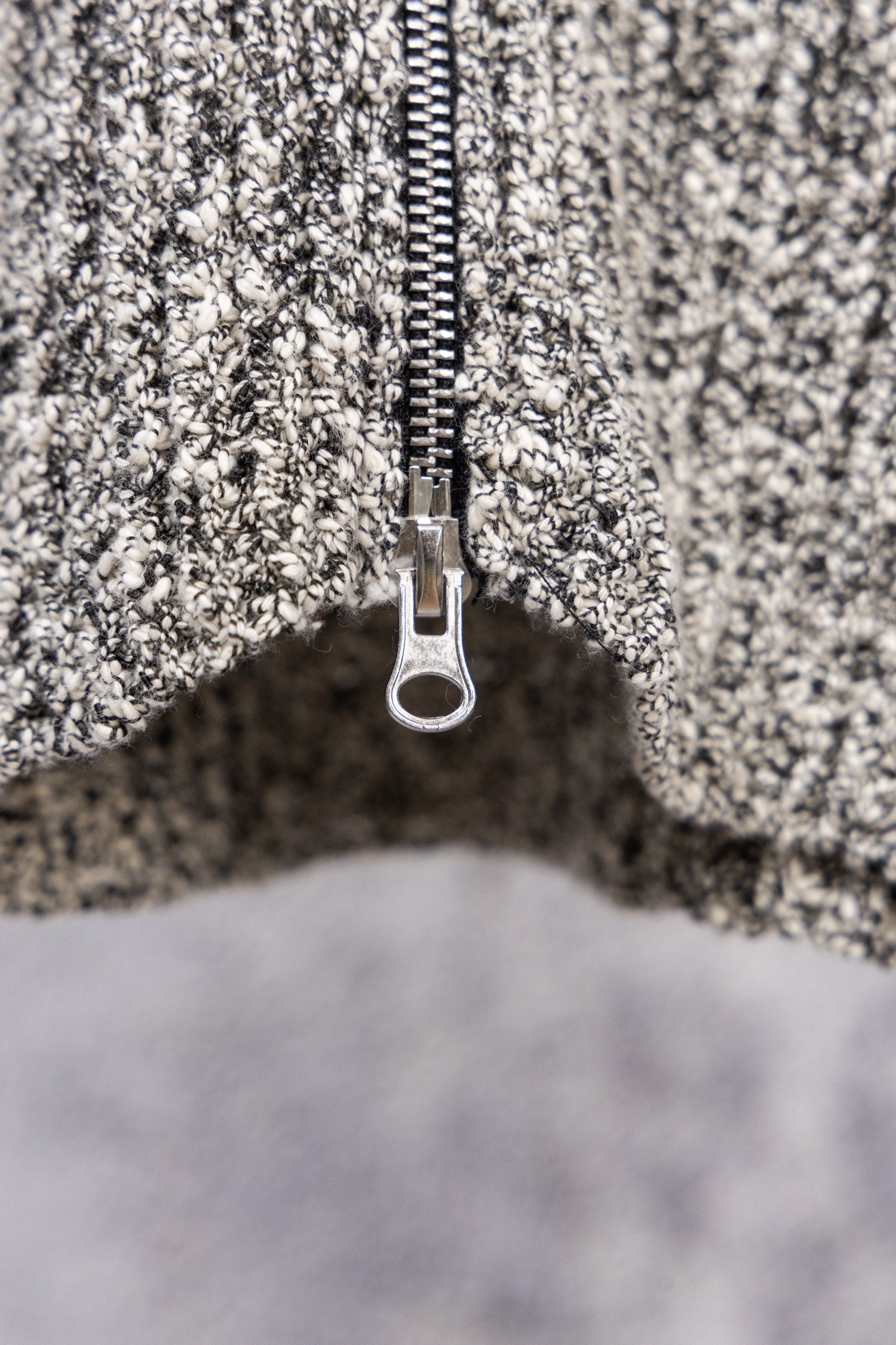 Stone Island speckled knit jacket zipper and metal pull tab, close-up