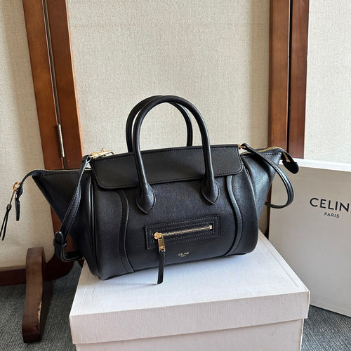 Celine handbag in dark leather with top handles, front flap pocket, and crossbody strap