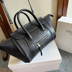 Celine handbag in dark leather with top handles, front zipper pocket, and gold hardware