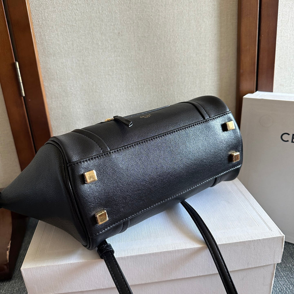 Celine leather handbag with gold-tone buckles and a long top-zip opening