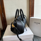 Celine handbag in dark leather with gold-tone hardware, top handles, and adjustable crossbody strap