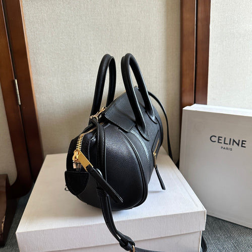 Celine handbag in dark leather with gold-tone hardware, top handles, and adjustable crossbody strap