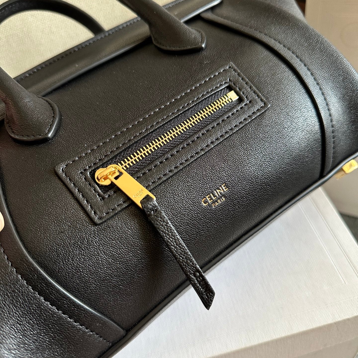 Celine handbag zipper pocket in dark leather with gold-tone zipper and small logo patch