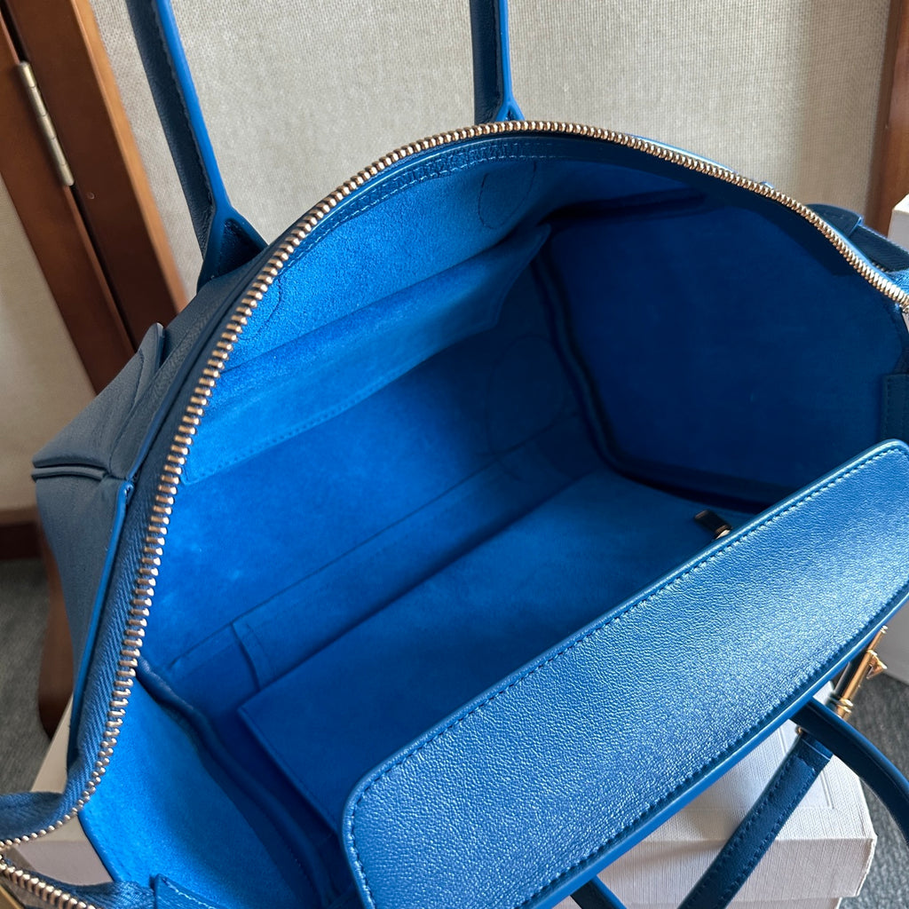 Blue leather bag interior lining with zippered opening and side pocket