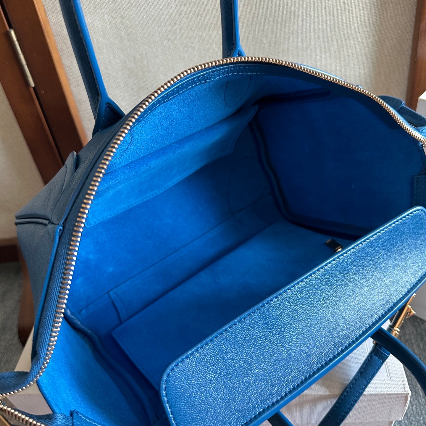 Blue leather bag interior lining with zippered opening and side pocket