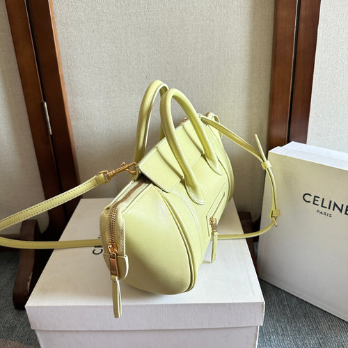 Light yellow Celine top-handle bag with adjustable shoulder strap and front zip pocket