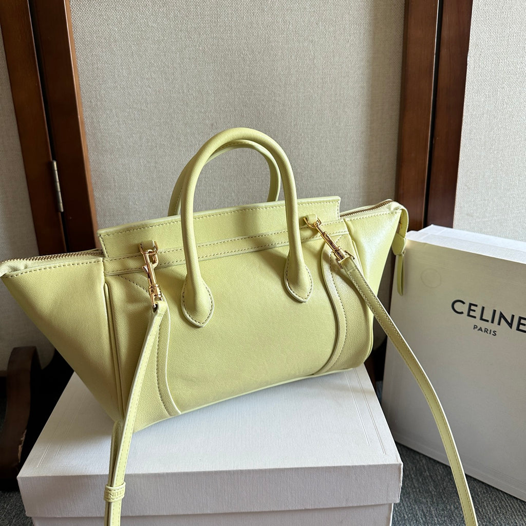 Light yellow Celine tote bag with front logo tab and crossbody strap