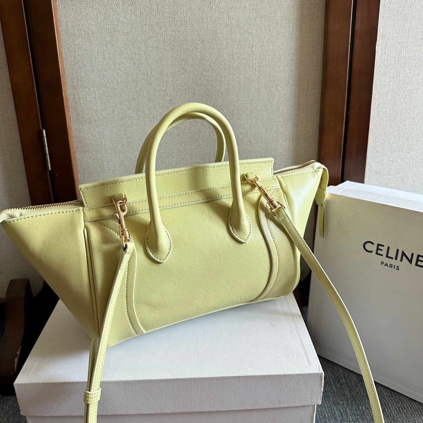 Light yellow Celine tote bag with front logo tab and crossbody strap