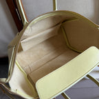 Light yellow Celine bag interior view with lined compartment and zipper opening