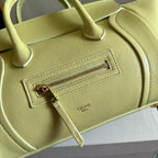 Light yellow Celine bag close-up of front zipper pocket and stitched logo