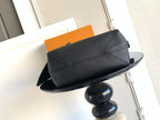 Black leather bag with top flap and stitched panel