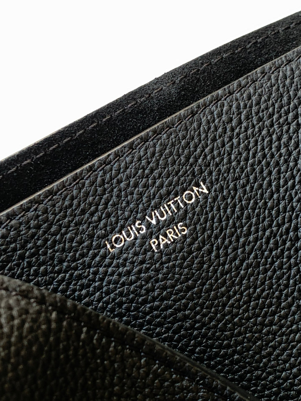 Black textured leather with embossed Louis Vuitton logo