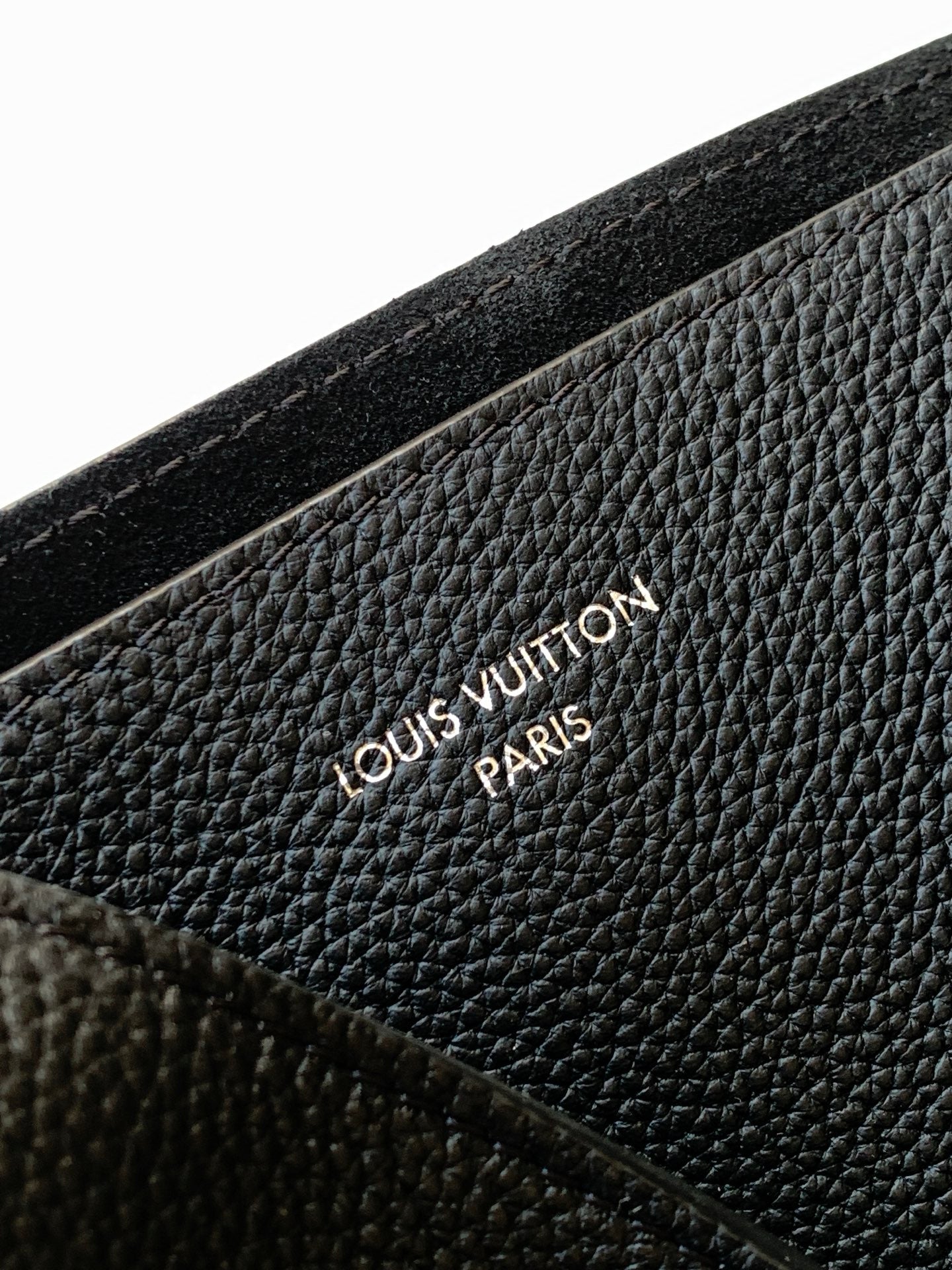 Black textured leather with embossed Louis Vuitton logo