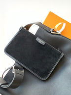 Black top-handle bag with crossbody strap and front pocket