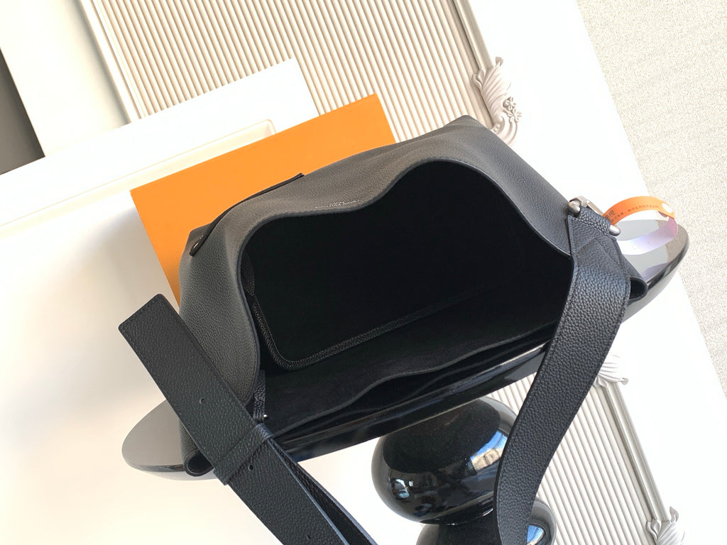Black shoulder bag open at the top, showing dark interior