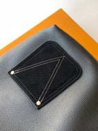 Black leather front patch pocket with contrast stitching and snap buttons