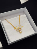 Gold-tone Dior pendant necklace with D charm and crystal drop on jewelry box