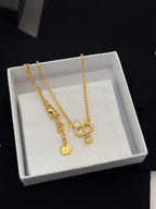 Gold-tone Dior pendant necklace with heart and D charms, layered chain on box