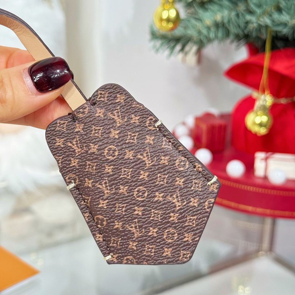 Brown monogram keychain accessory with strap loop and stitched edges