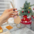 Beige keychain accessory with cartoon animal face charm and gold key ring