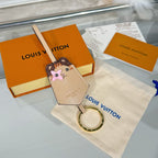 Beige keychain accessory with cartoon animal face charm and gold key ring